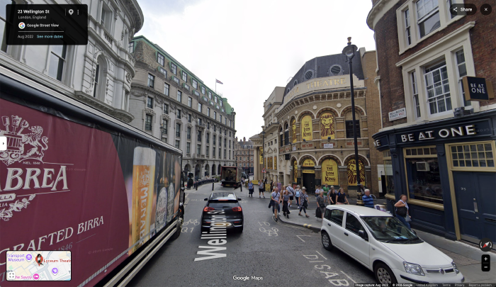 Google Map Street View of London Lyceum Theatre: busy two lane road with trucks, SUVs, pedestrian and cycle lane.